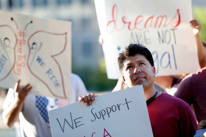 Daniel Tapia holds a sign during a support rally for DACA recipients last month at City Hall...