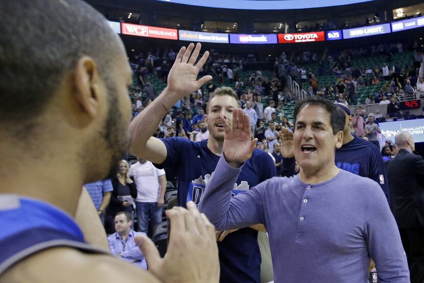 Dallas Mavericks owner Mark Cuban, right, celebrates with Dallas Mavericks' Devin Harris,...