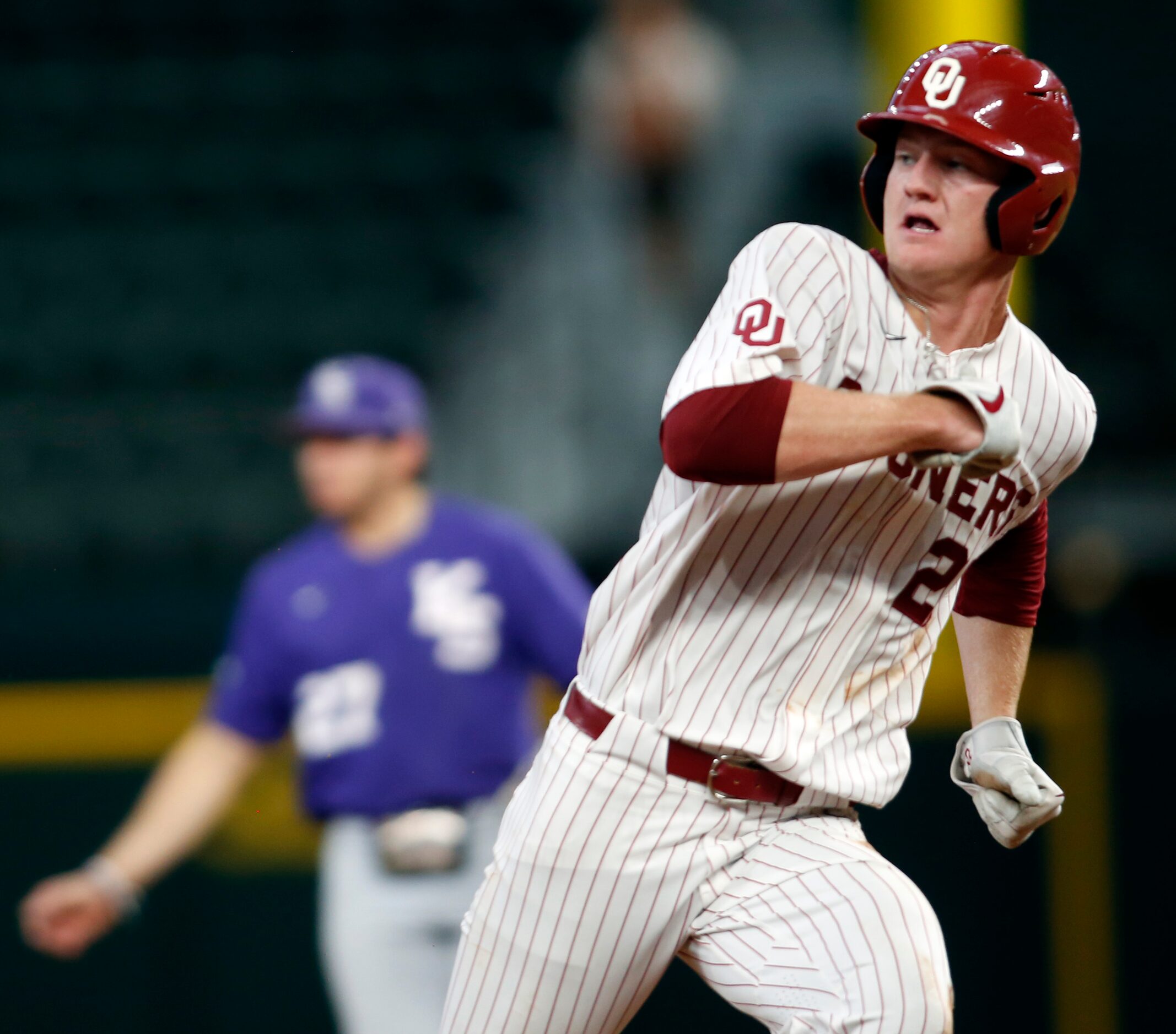 Oklahoma Sooners first baseman Blake Robertson (26) looks over his shoulder as he hustles to...