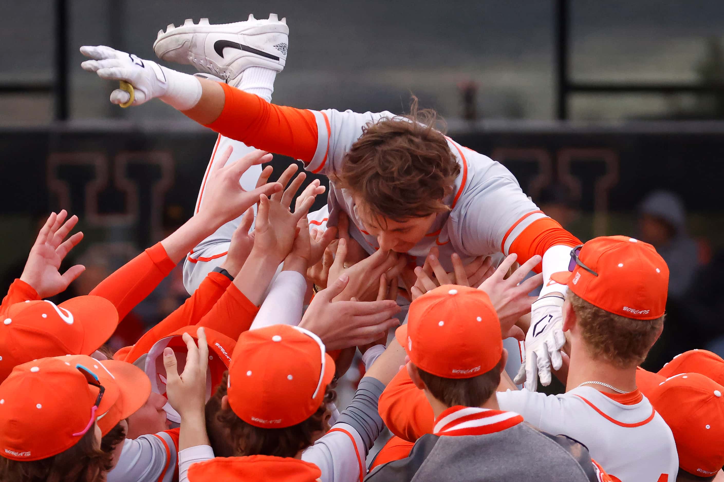 Celina High batter Major Brignon (8) is congratulated by his teammates after hitting a two...