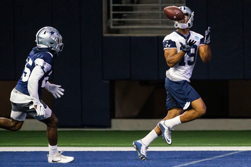 Dallas Cowboys wide receiver Amari Cooper (19) catches a touchdown pass as safety Xavier...