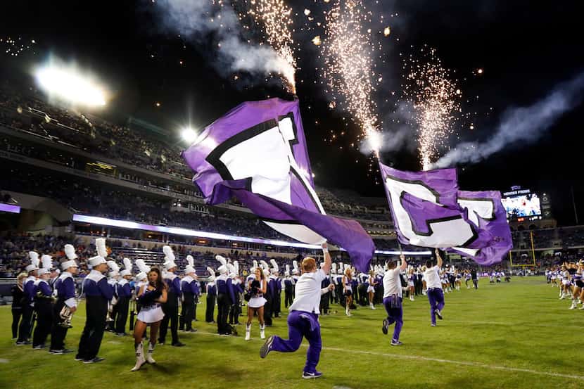 FILE - The TCU Horned Frogs cheer squad races onto the field ahead of the football team...