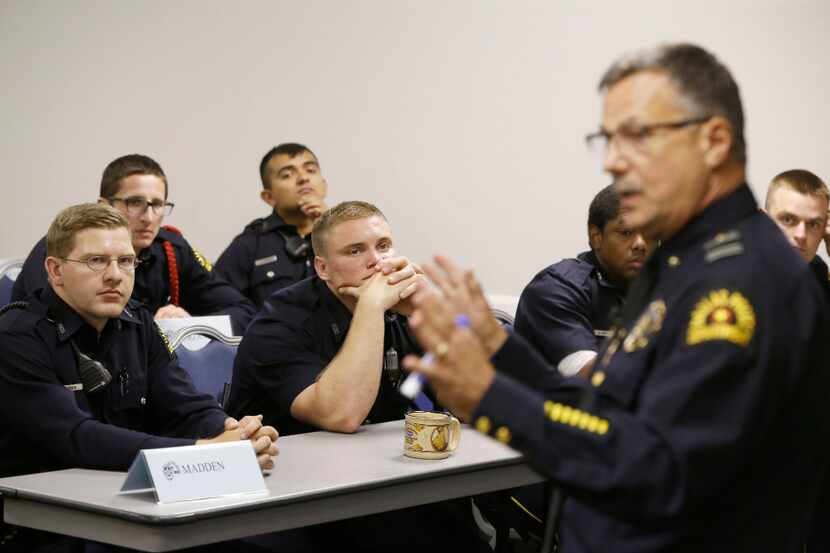 Bryan Madden (left) and Garrett Wickens listen as Deputy Chief Jeffrey Cotner teaches an...