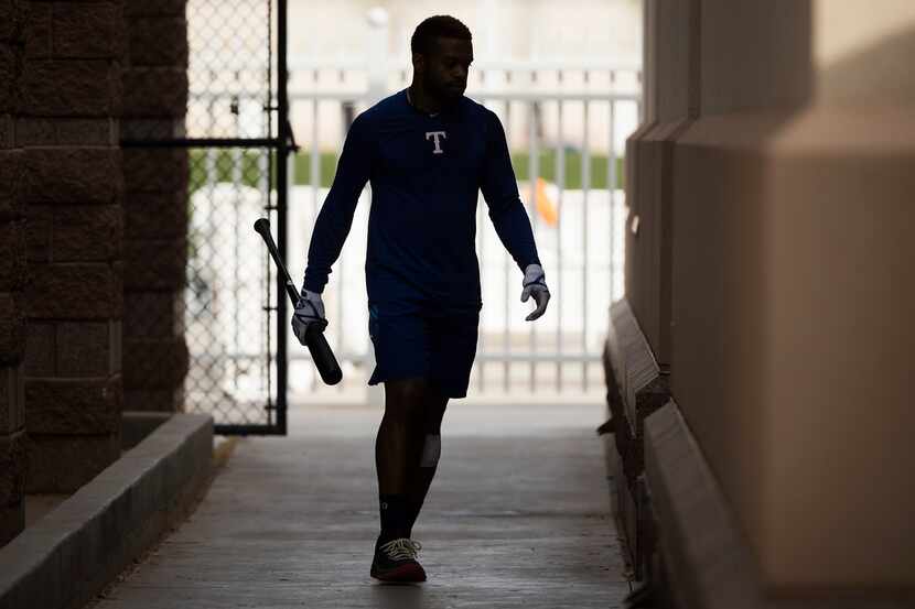 Texas Rangers outfielder Delino DeShields walks to the clubhouse from the batting cages...