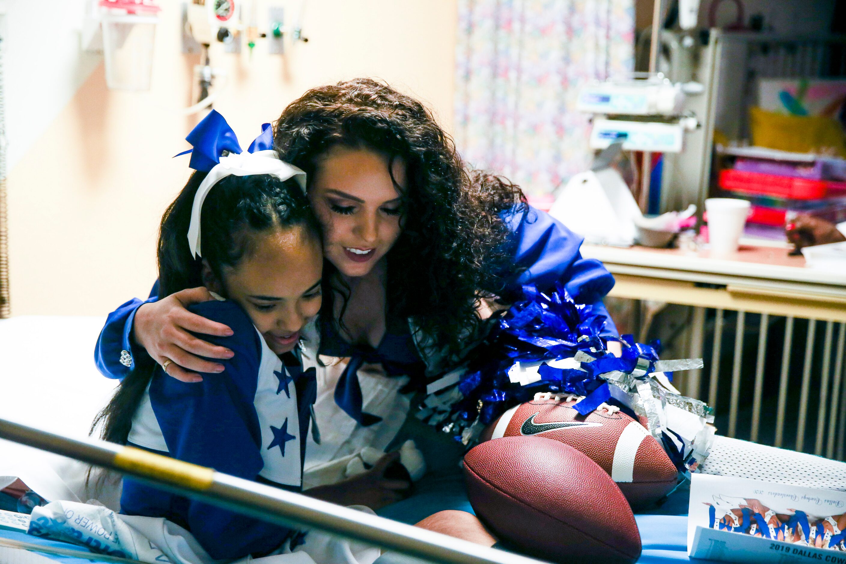 Dallas Cowboys cheerleader Maddie Missingill embraces Deshony âShonyâ Carawayâs, 12,...