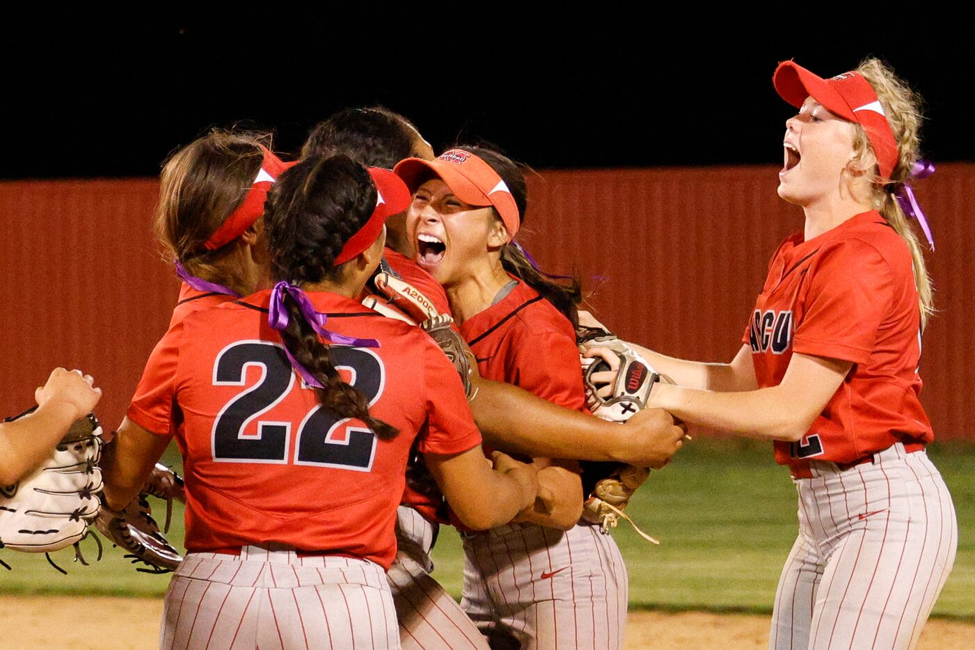 Marcus right fielder Dani Vu (center) is greeted by teammates after making a leaping catch...