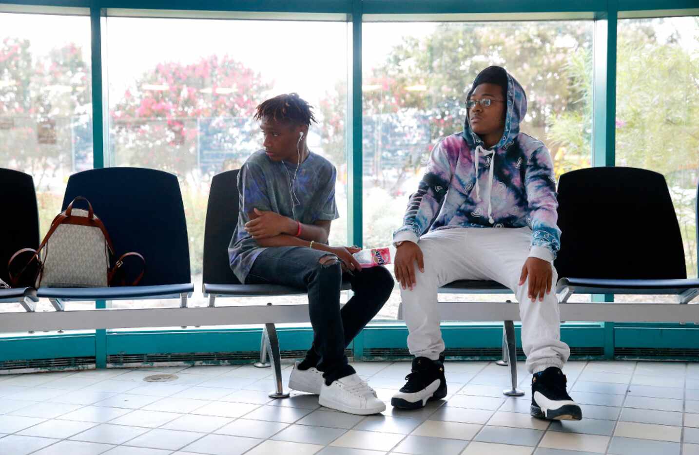 Broderick (right), 16, and Trayvon, 14, waited in the Arlington police headquarters lobby...