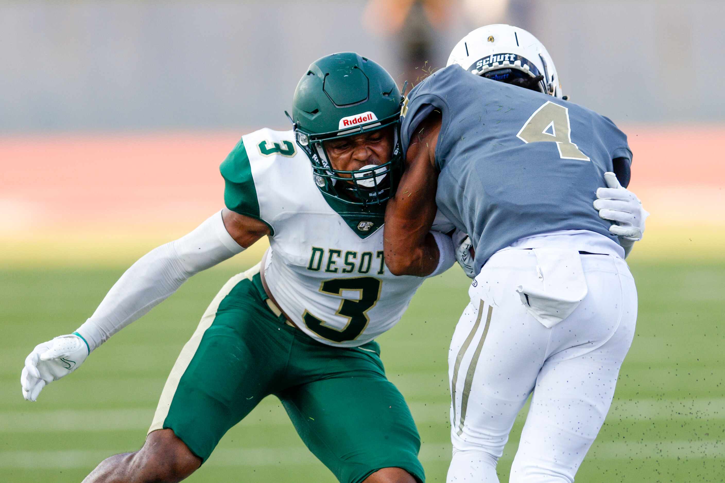 DeSoto linebacker Brandon Booker (3) tackles South Oak Cliff running back Khalill Ewell (4)...