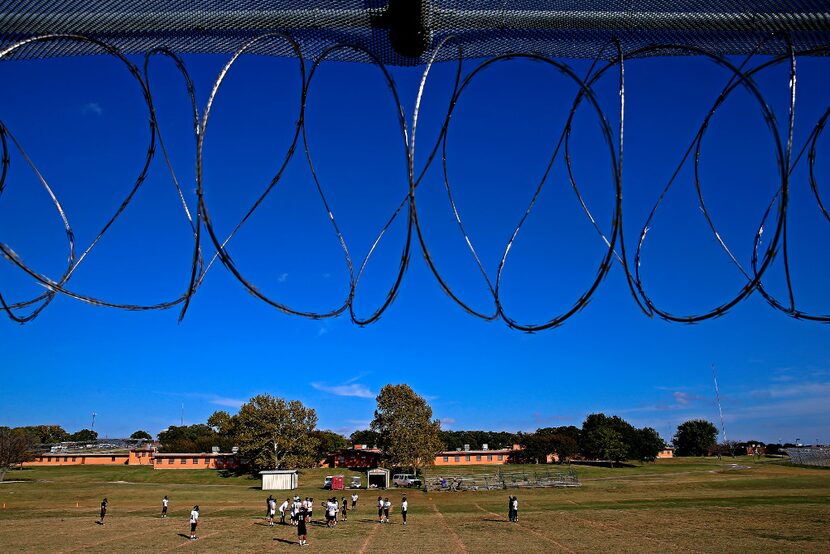 Football players practice at Gainesville State School.