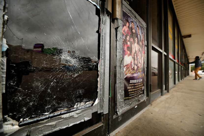 Broken glass and outdated casino posters are visible on the vacated storefront of 12125...