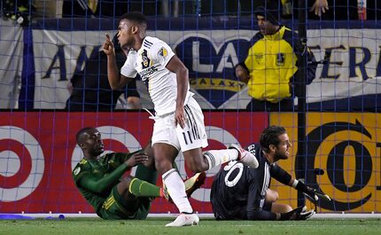 Los Angeles Galaxy forward Ola Kamara, center, celebrates his goal as Portland Timbers...