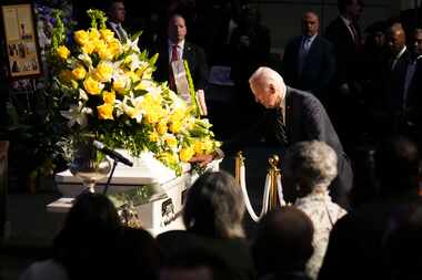 President Joe Biden reaches out to touch the casket of former U.S. Rep. Eddie Bernice...