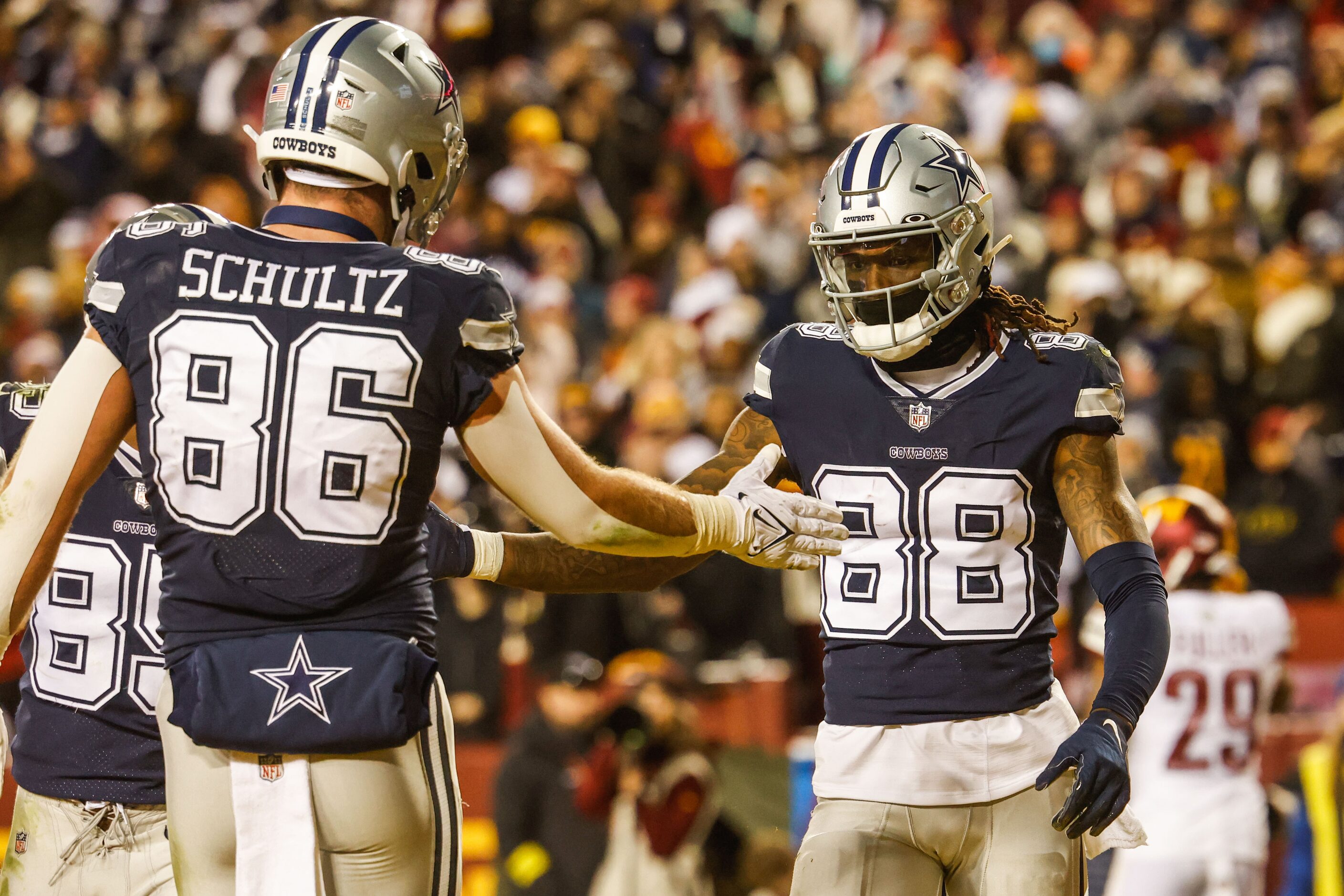 Dallas Cowboys wide receiver CeeDee Lamb (88) celebrates a touchdown with tight end Dalton...