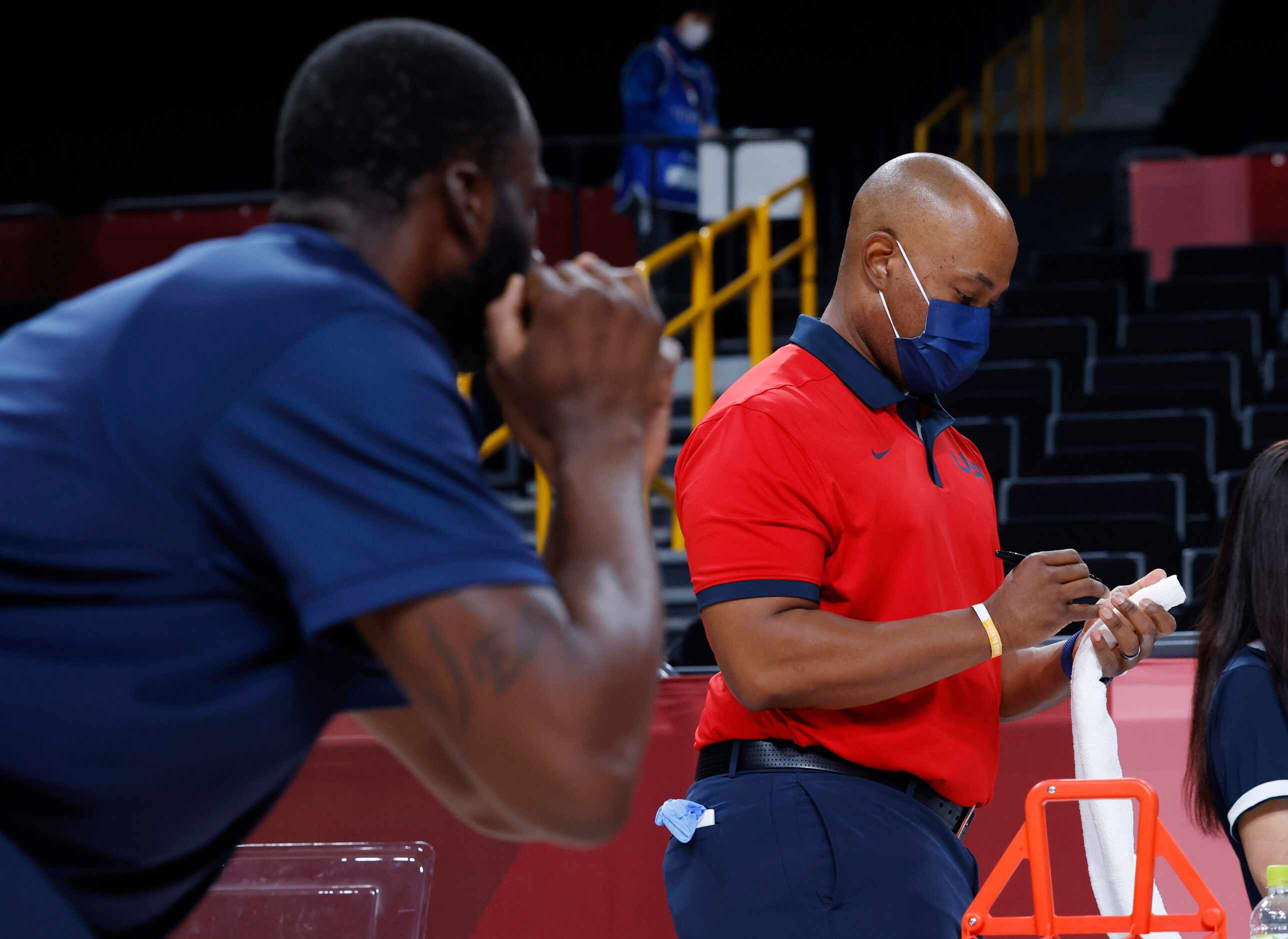 USA’s head athletic trainer Dionne Calhoun marks towels for each player as Draymond Green...