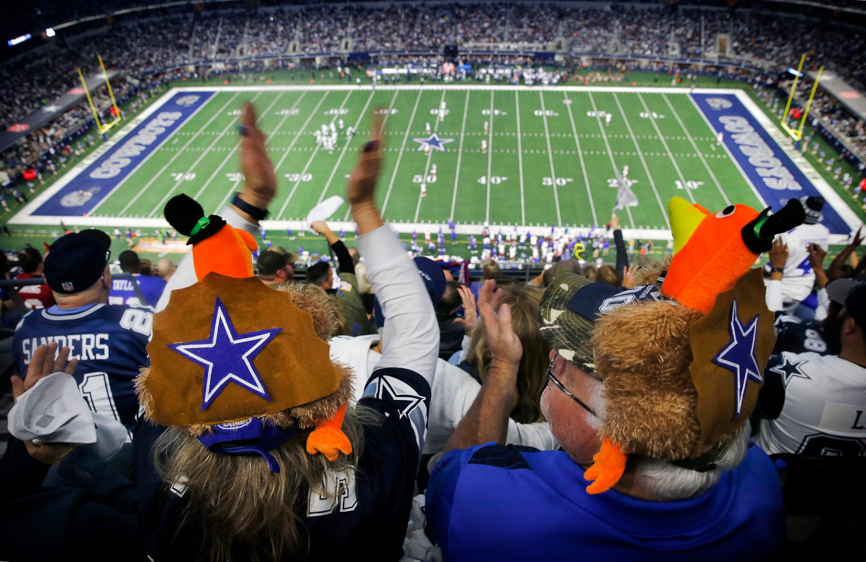 Dallas Cowboys fans Jania Lenington (left) of Midvale, Utah and her husband Ryan donned...