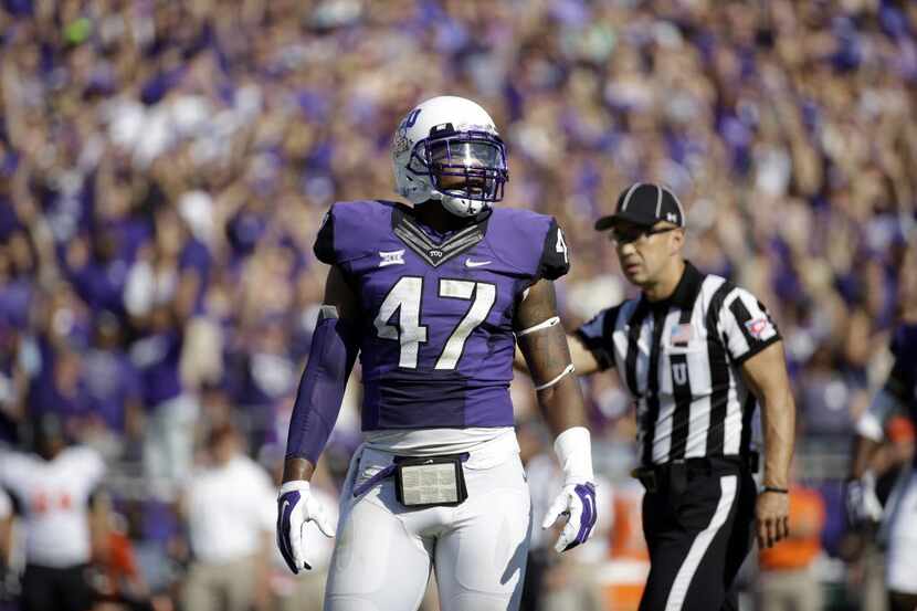 TCU linebacker Paul Dawson (47) stands on the field looking to the sideline during the first...