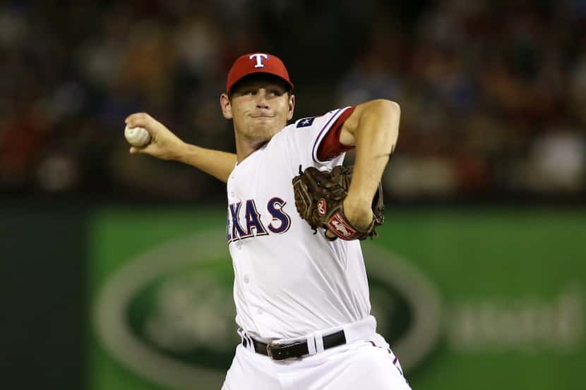 Texas Rangers starting pitcher Nick Tepesch (49) works against the Oakland Athletics in the...