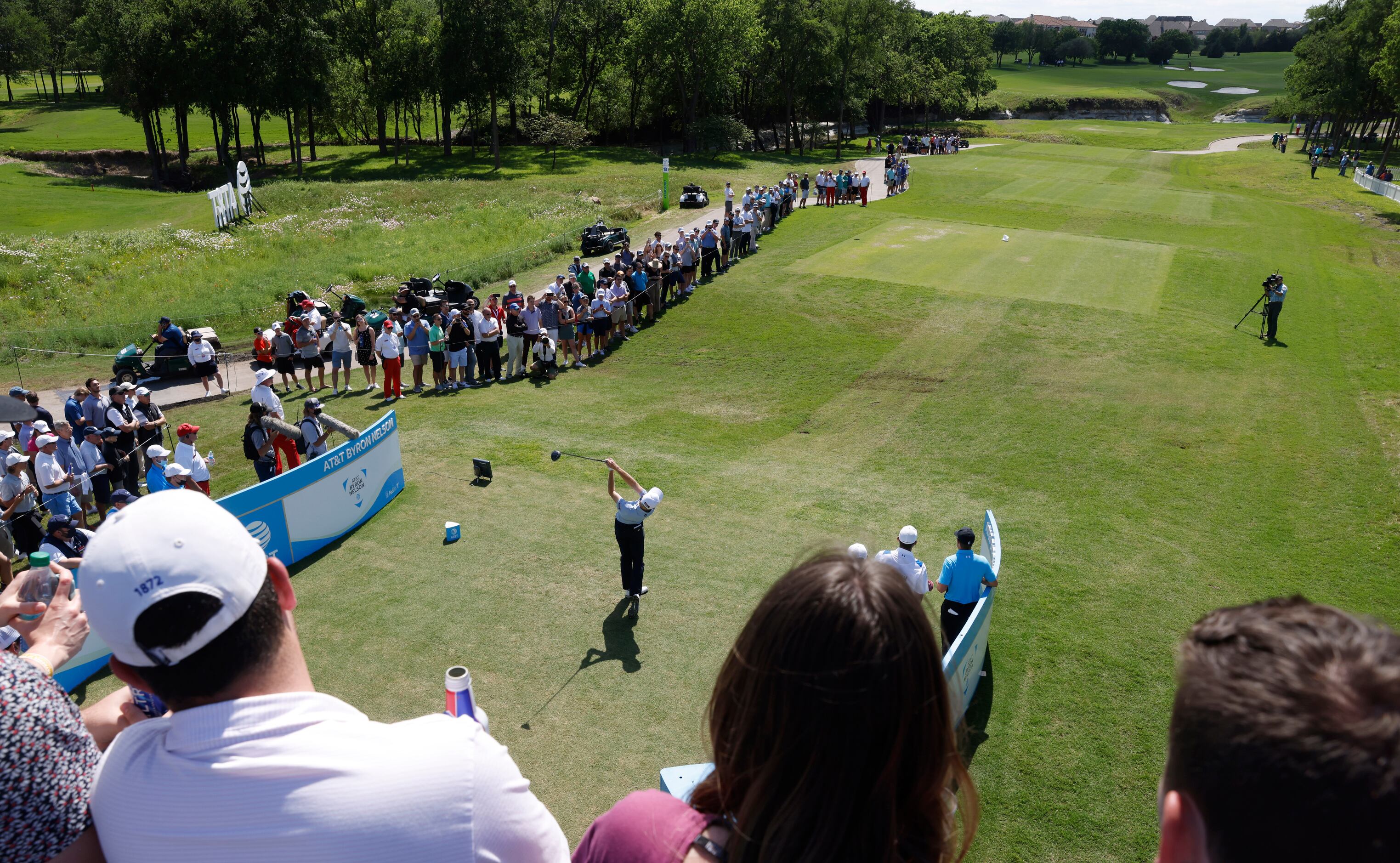 Fans watch as Will Zalatoris tees off on the 13th hole during round 1 of the AT&T Byron...