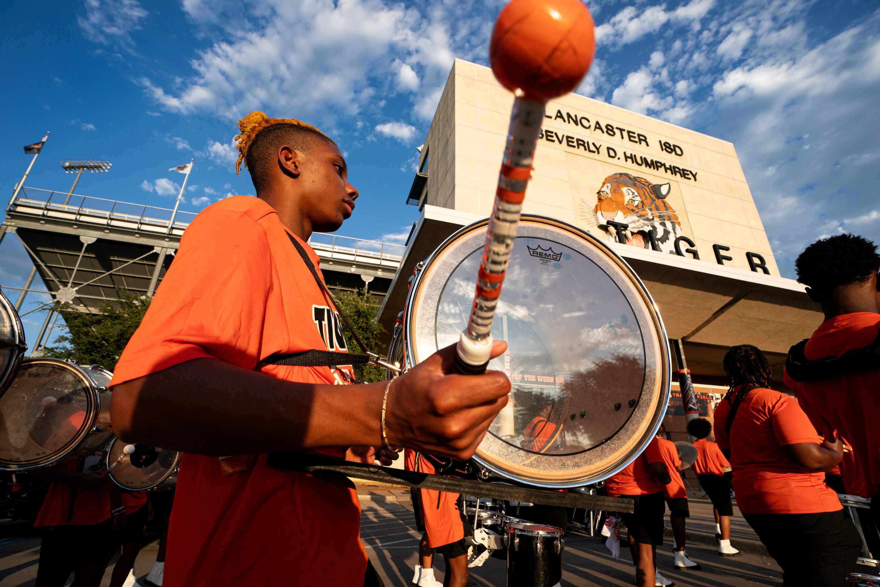 The Lancaster band marches into the stadium before a high school football game against...