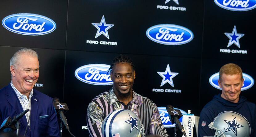 Dallas Cowboys CEO Stephen Jones, left, laughs along with defensive end Demarcus Lawrence...