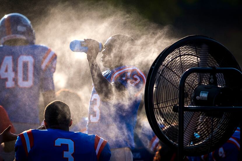 Duncanville wide receiver Roderick Daniels cools off on the sidelines during the first half...