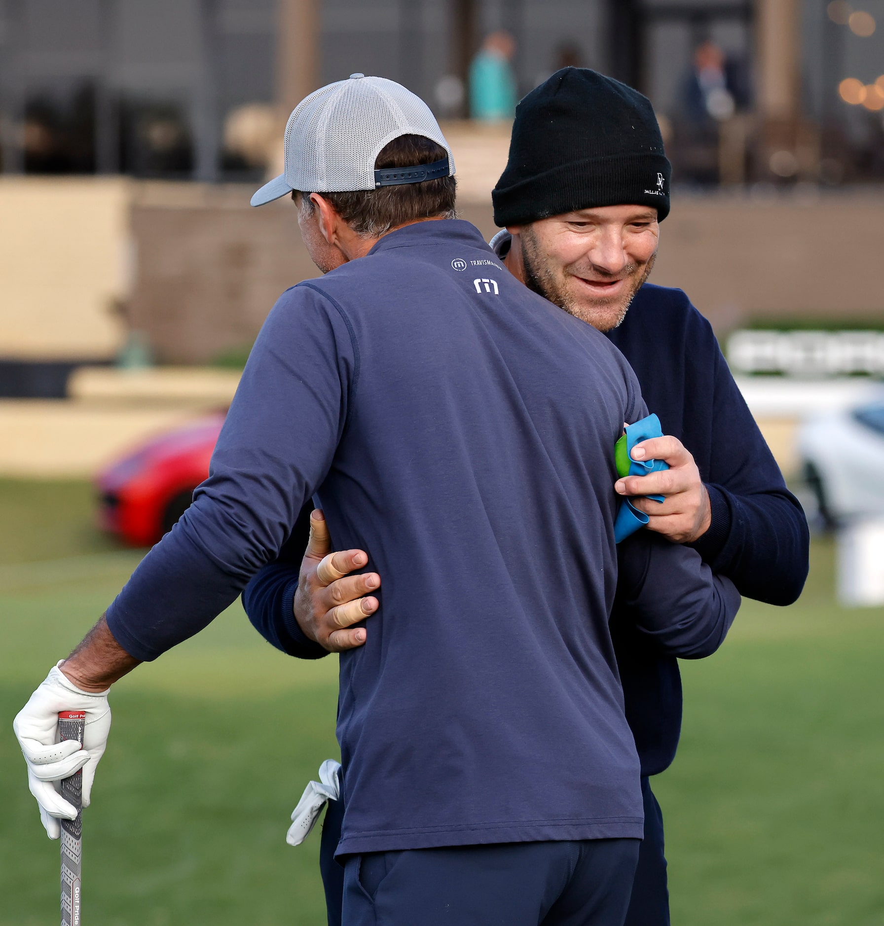 Former Dallas Cowboys quarterback Tony Romo (right) receives a hug from former Dallas Stars...