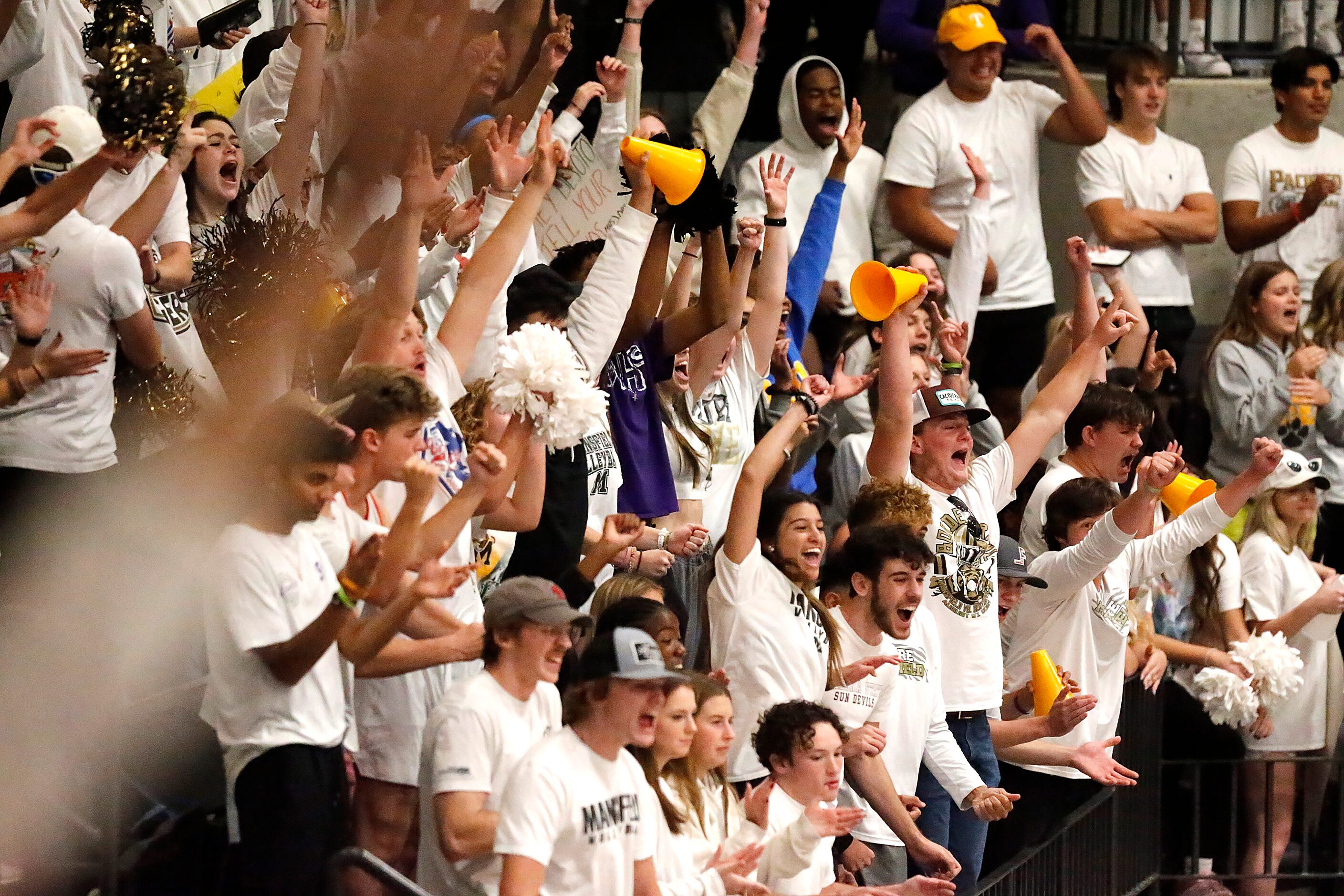 The Mansfield High School student section celebrates a point during game two as DeSoto High...