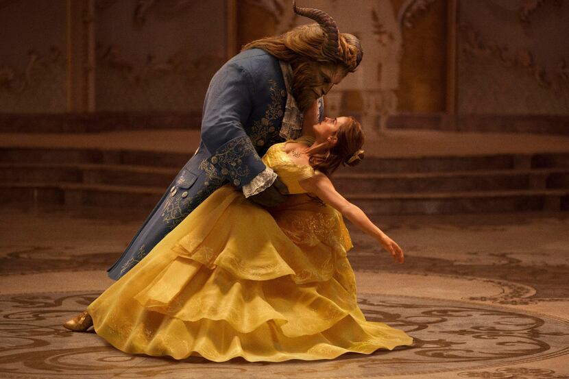 This image released by Disney shows Dan Stevens as The Beast, left, and Emma Watson as Belle...