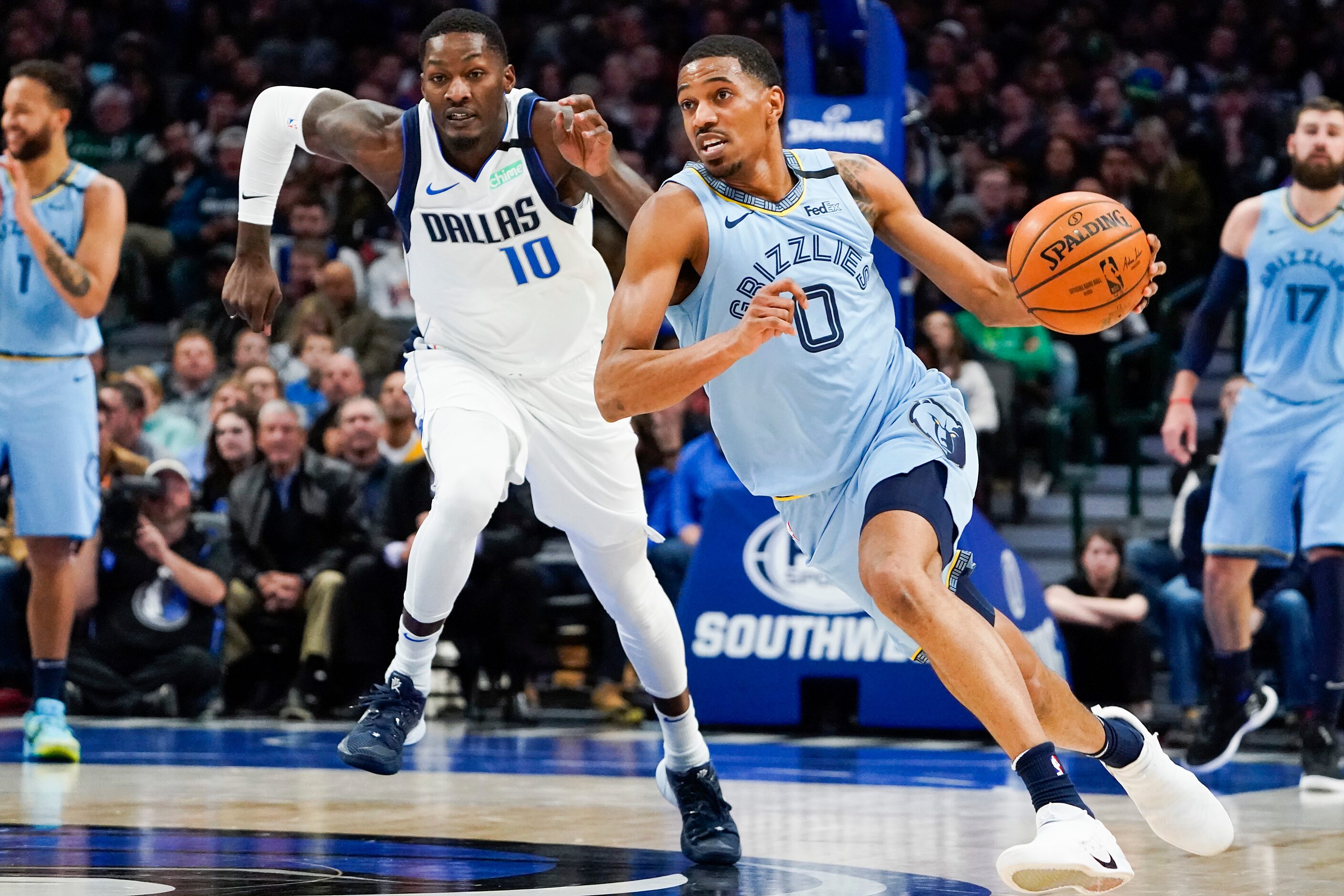 Memphis Grizzlies guard De'Anthony Melton (0) races up the court past Dallas Mavericks...