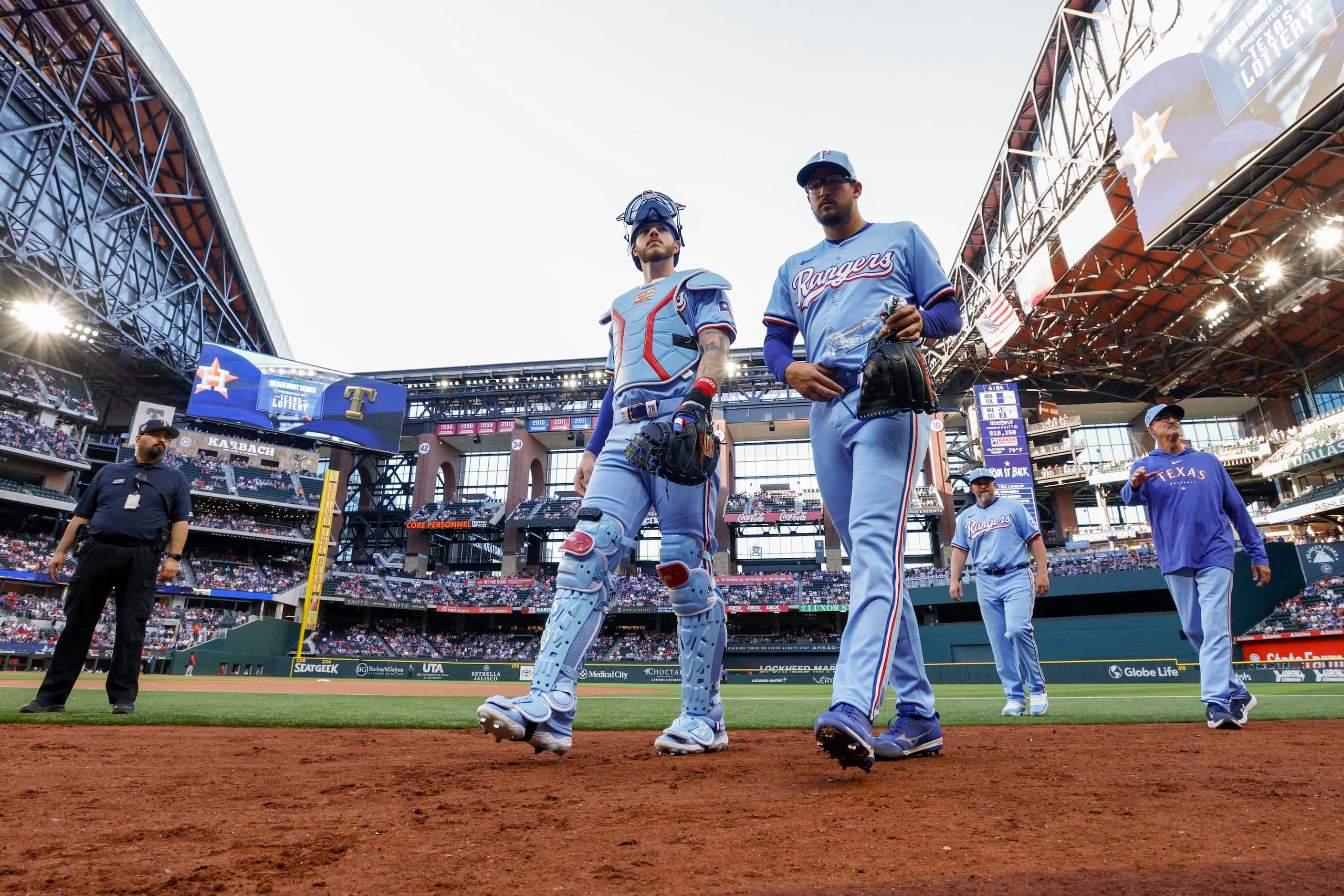 Texas Rangers catcher Jonah Heim and starting pitcher Dane Dunning walk to the dugout before...