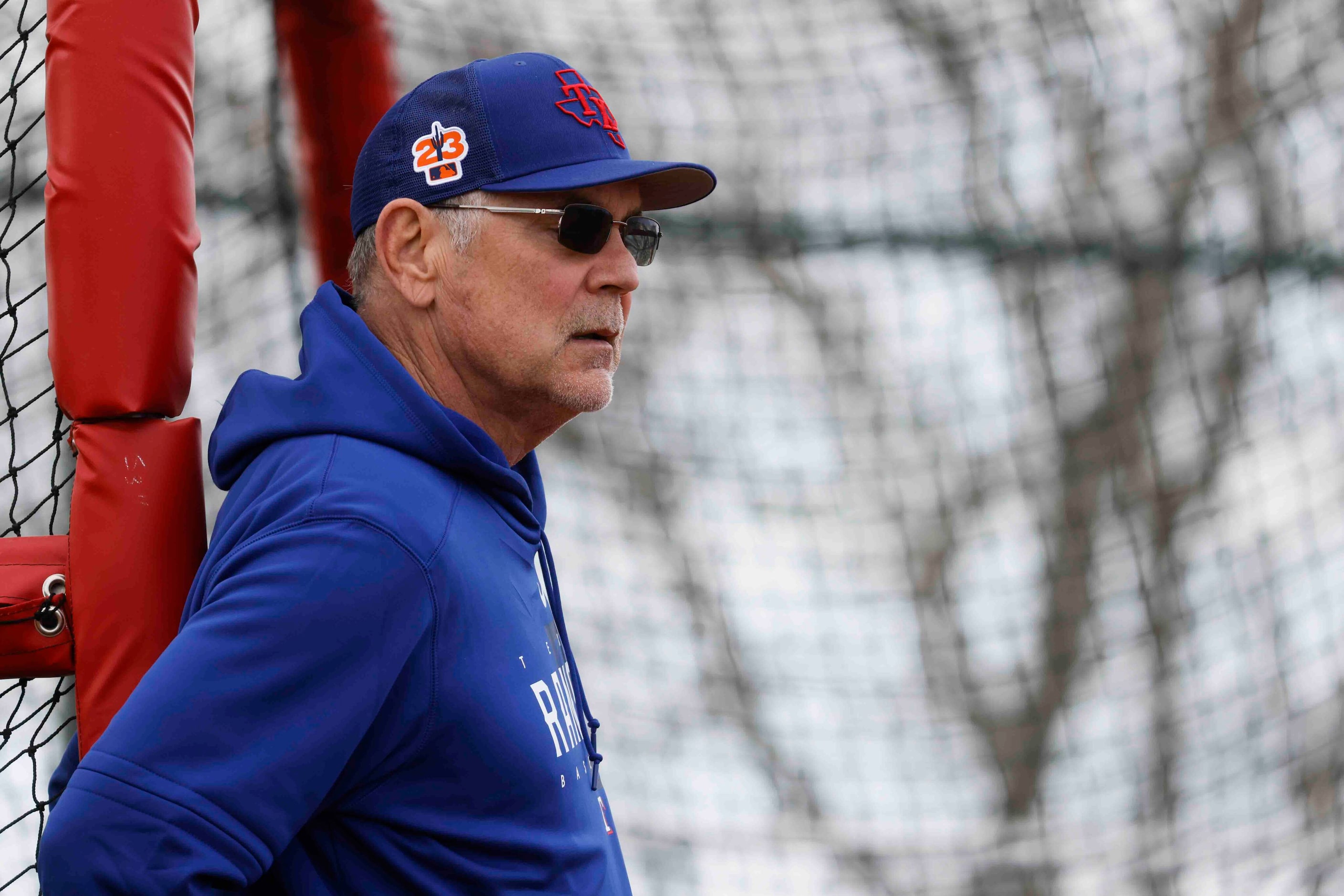 Texas Rangers manager Bruce Bochy watches the players practice during a spring training...