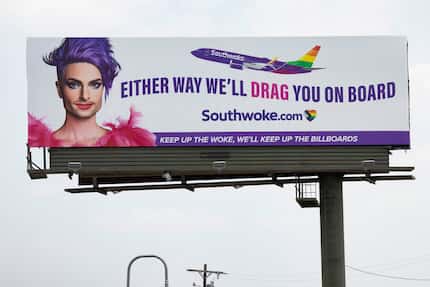 A billboard featuring a “Southwoke” plane and a person in drag with the words “Either way...