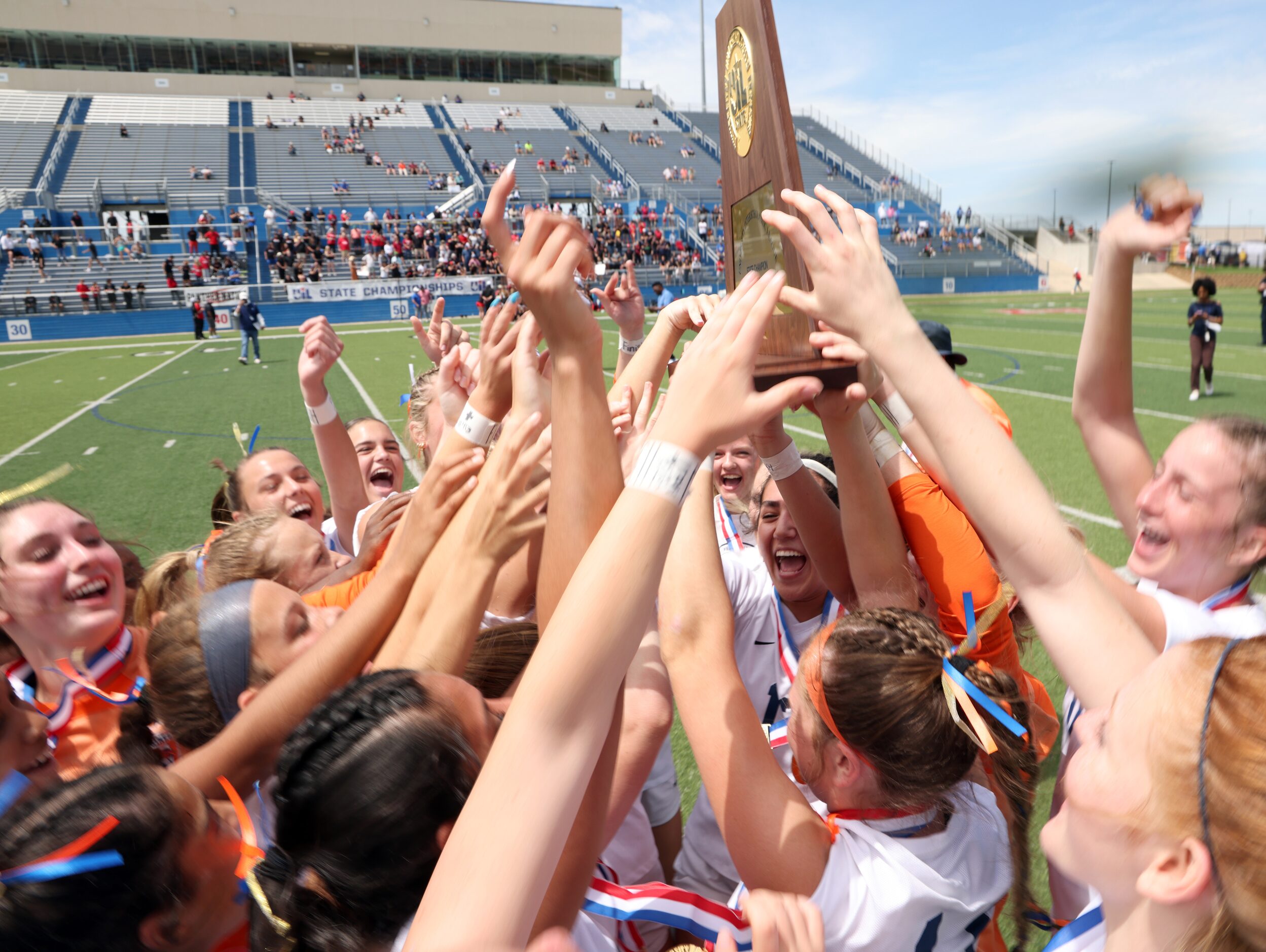 Frisco Wakeland players celebrate with their state championship trophy following their 3-2...