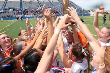Frisco Wakeland players celebrate with their state championship trophy following their 3-2...