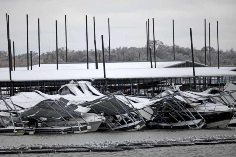 The roof of the boat dock at Pier 121 Marina on Lake Lewisville collapsed under the weight...