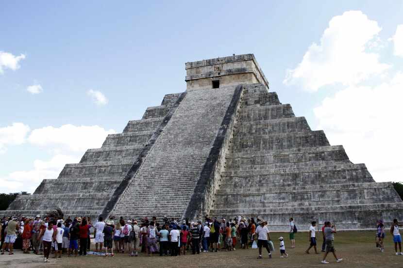 People gather in front of the Kukulkan Pyramid in Chichen Itza, Mexico, Thursday, Dec. 20,...