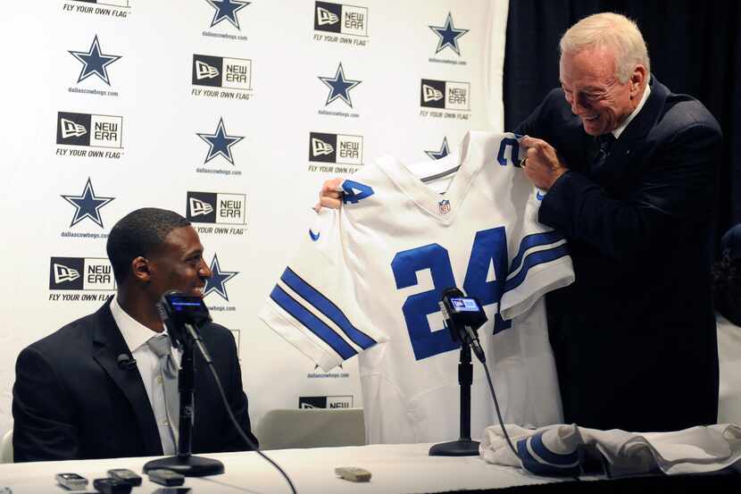 Cowboys owner Jerry Jones presents Dallas Cowboys' first-round draft choice Morris Claiborne...
