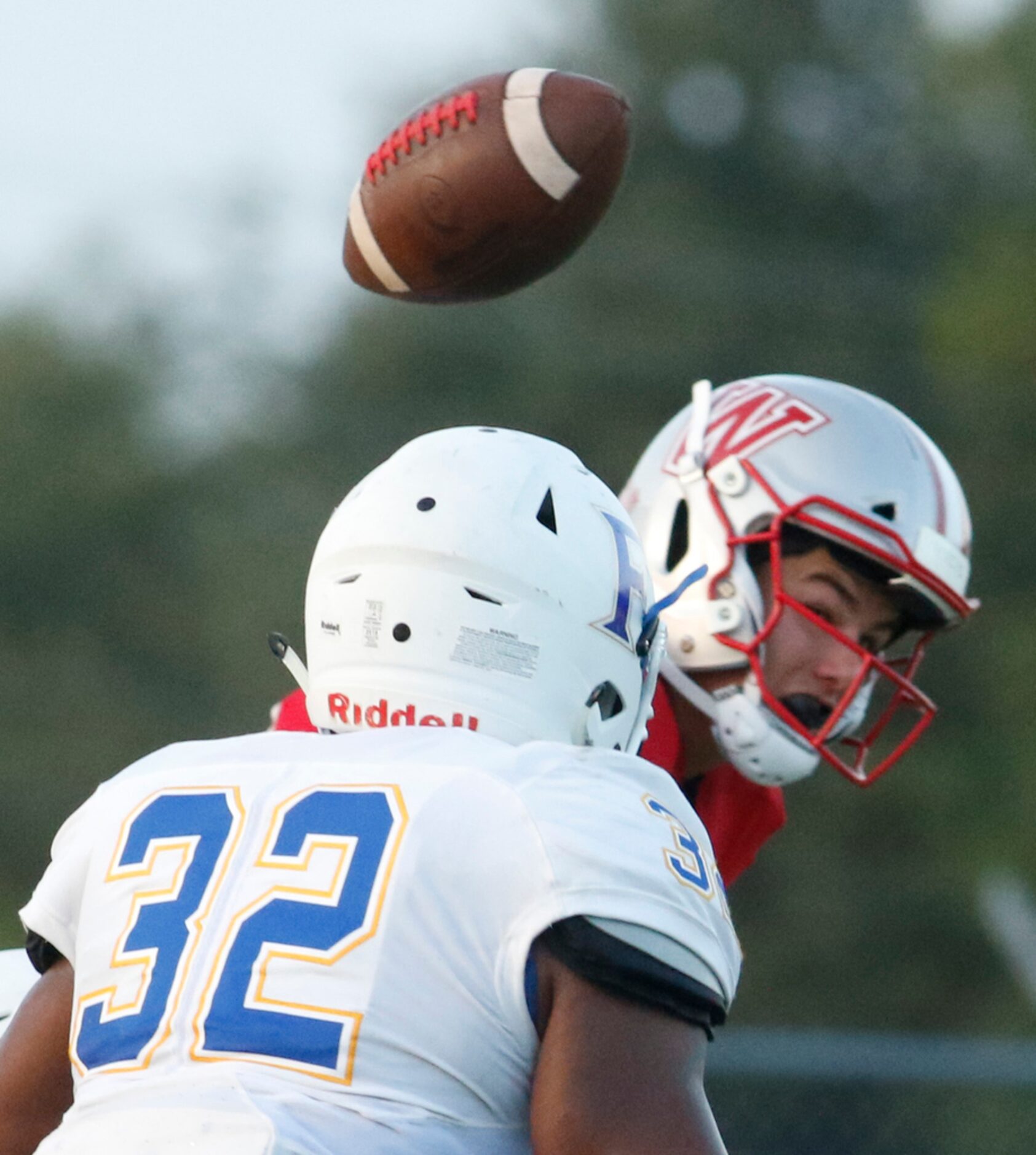 Dallas Woodrow Wilson quarterback Sam Fennegan (16) is hit in the backfield resulting in an...