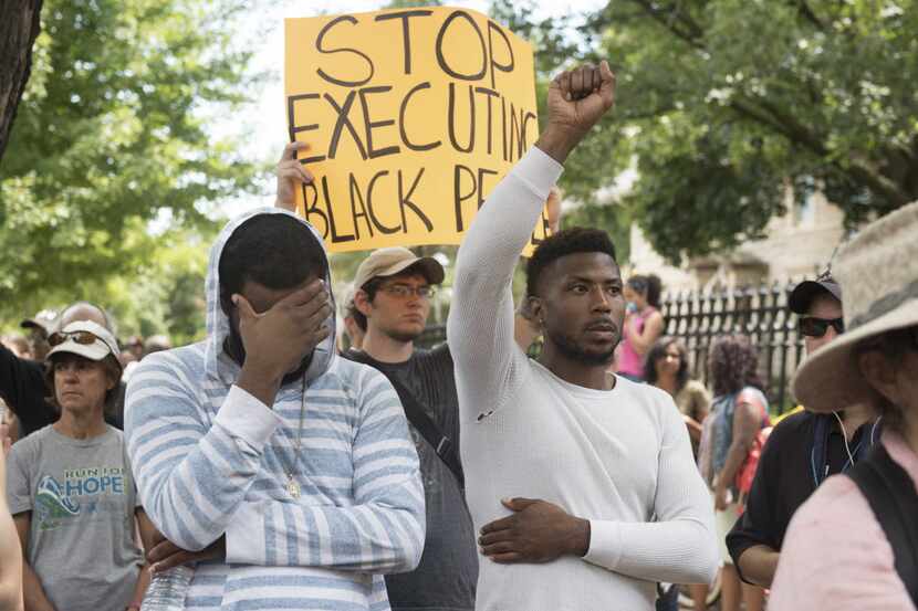 Demonstrators at a rally in front of the Governor's Residence, sparked by the shooting death...