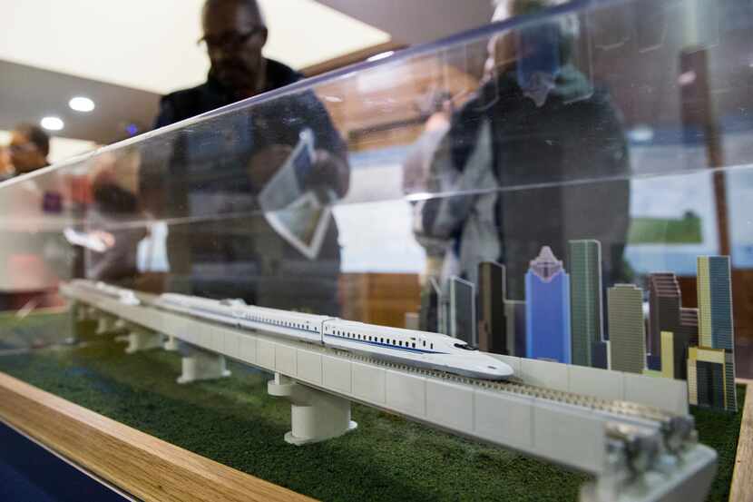 People walked past a model of a $15 billion Dallas to Houston high-speed rail line during an...