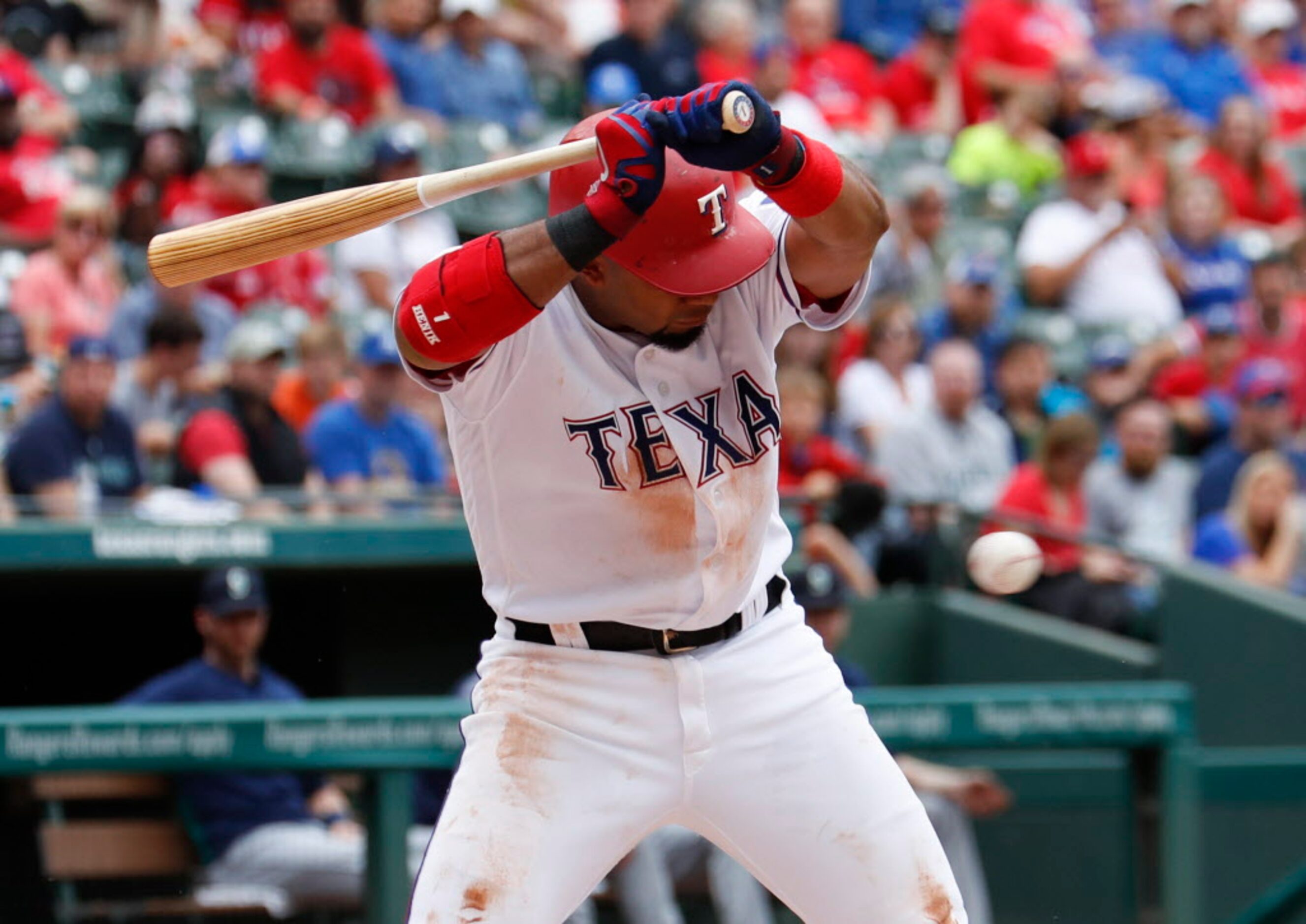 Texas Rangers' Elvis Andrus reacts as he's hit by a pitch by Seattle Mariners starting...