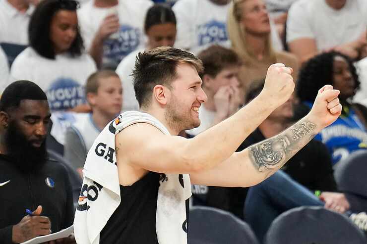 Dallas Mavericks guard Luka Doncic celebrates on the bench during the second half in Game 5...