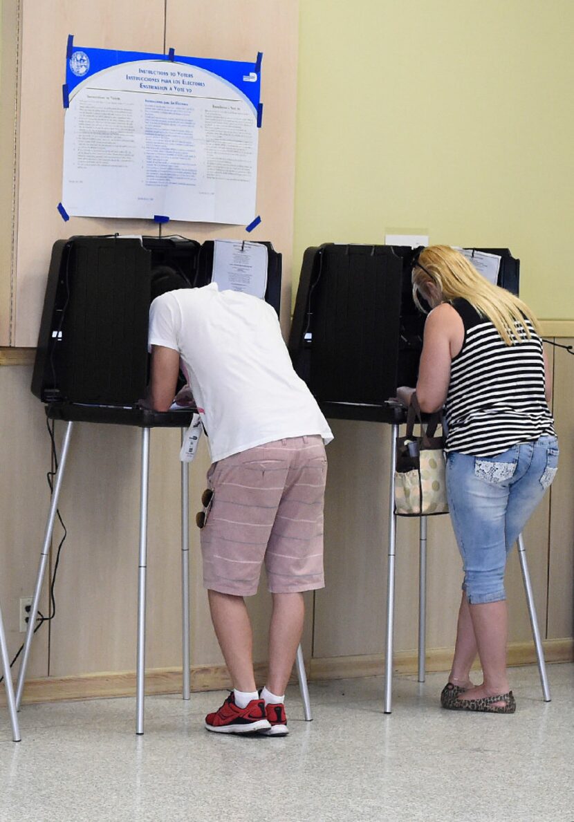 Young voters cast ballots in the presidential election at a polling center in Miami on Nov....