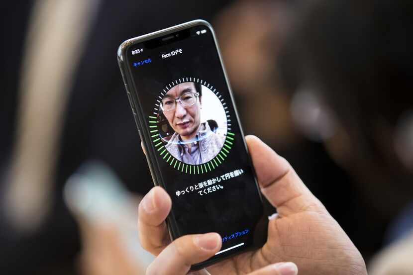A customer tries Face ID for the iPhone X at the Apple Omotesando store in Tokyo.