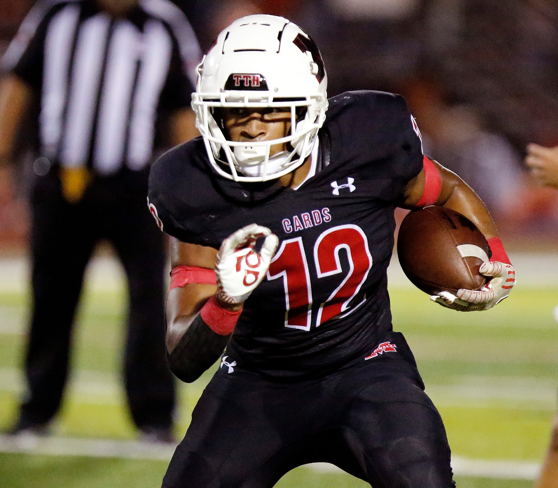 Melissa High School running back Ashton Mitchell-Johnson (12) looks for room to run during...