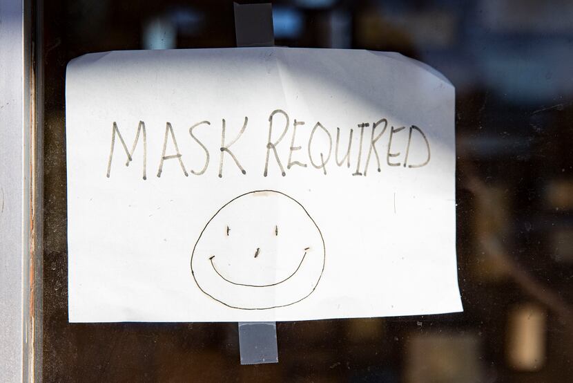 A hand drawn mask required sign at Oliver's Hair Replacements on Greenville Ave. in Dallas...