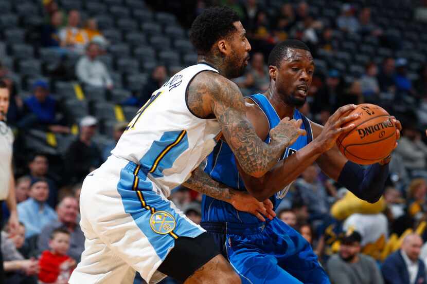 Denver Nuggets forward Wilson Chandler, left, defends as Dallas Mavericks forward Harrison...