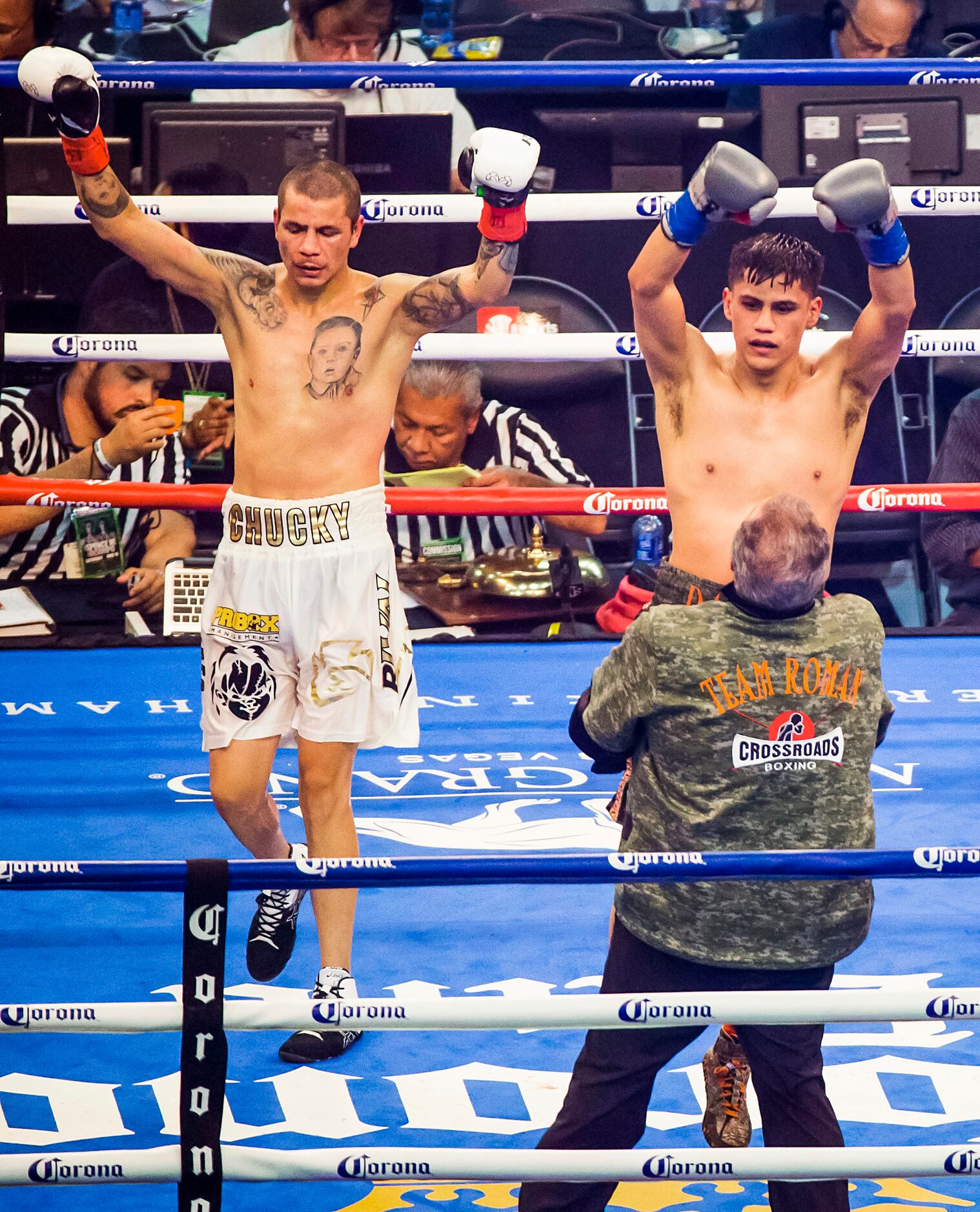 Daniel Roman (right), of Los Angeles, celebrates after the final bell of his fight with...