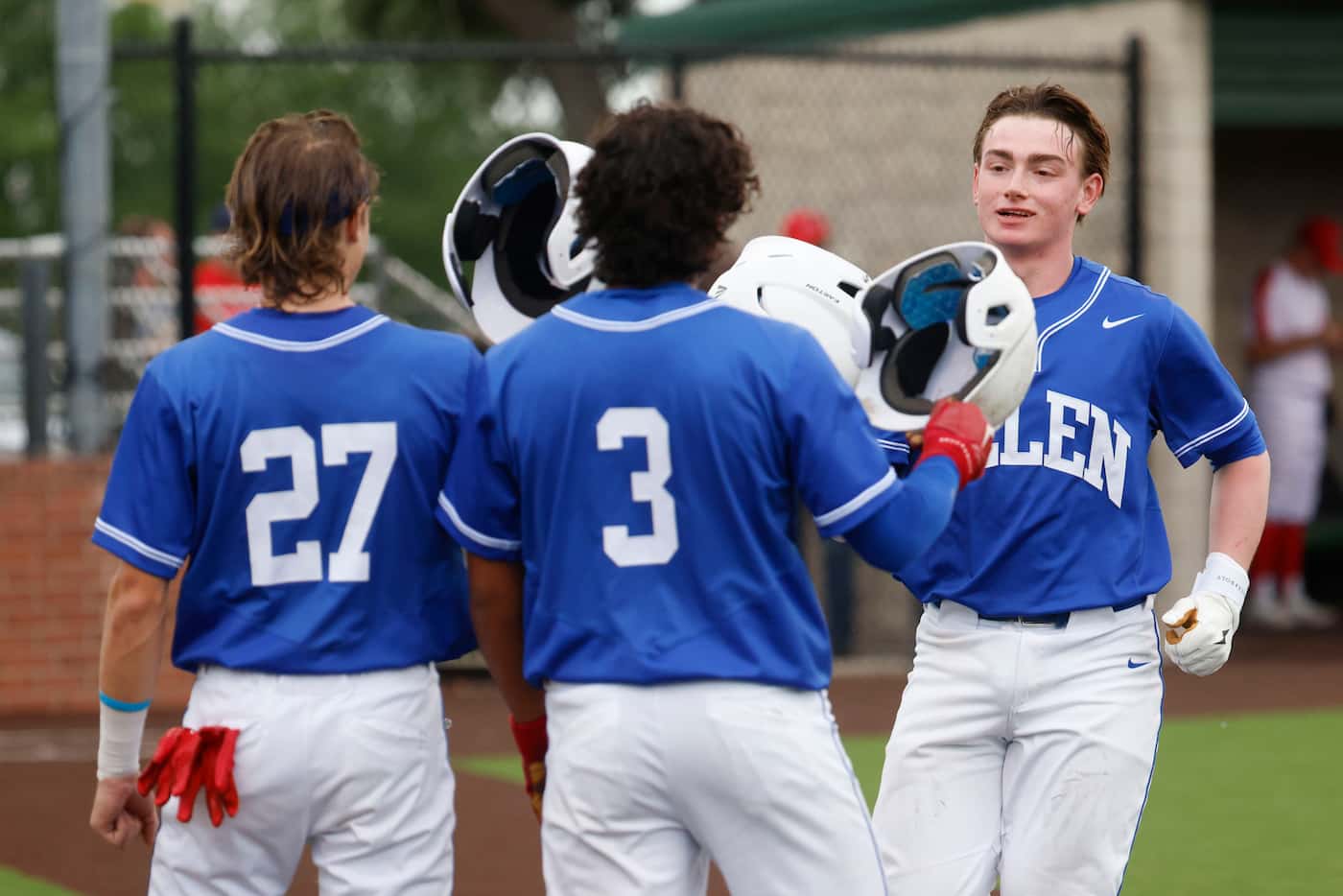  Allen high’s Caden Young (right) is greeted by his teammates after hitting a homerun during...