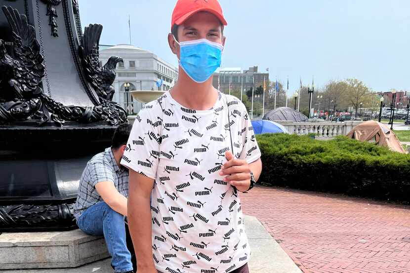 Manuel Torres, a 37-year-old mechanical engineer from Venezuela, waits with a small group of...